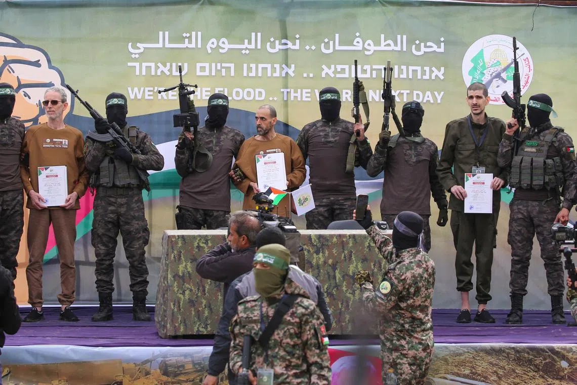 (From left, holding certificates) Mr Ohad Ben Ami, Mr Eli Sharabi and Mr Or Levy were handed over by Hamas militants on Feb 8.