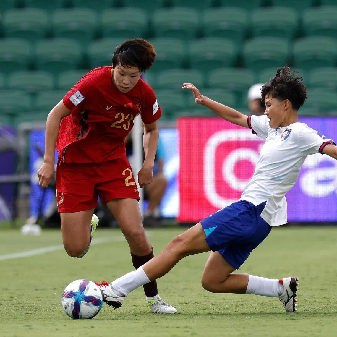 Shao Ziqin of China is tackled by Teng Pei-Lin of Chinese Taipei during their Women's Asian Cup quarter-finals.
