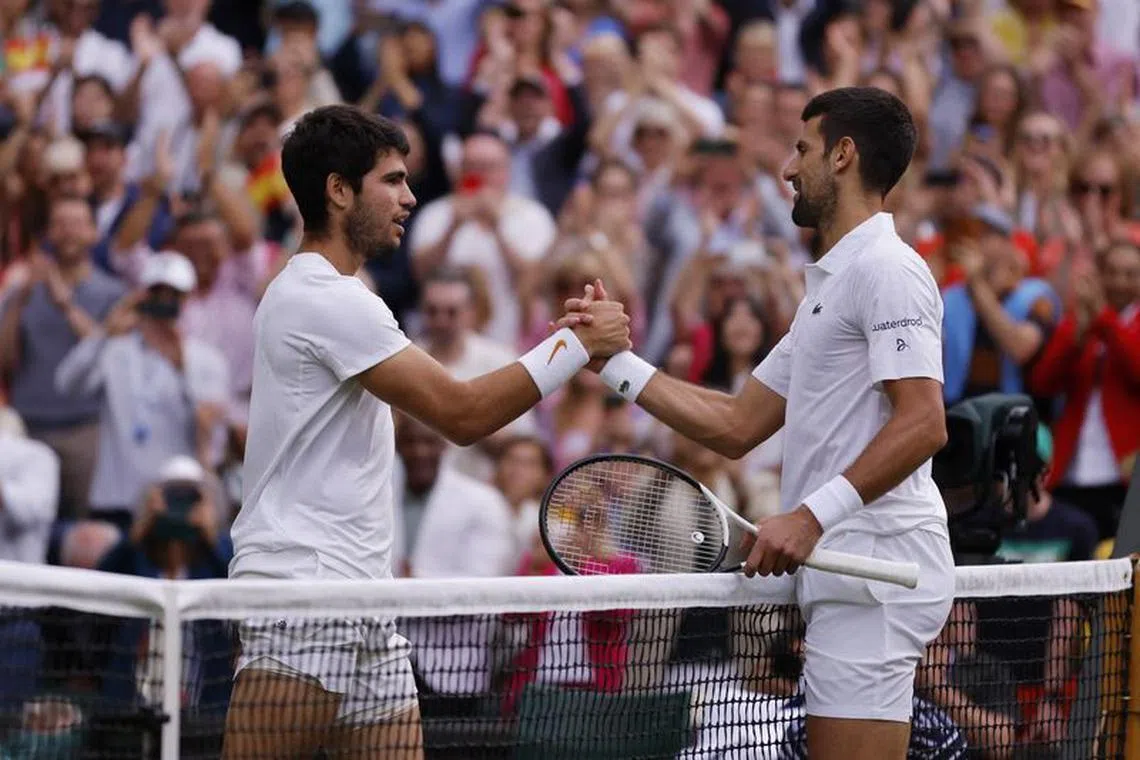 FILE PHOTO: Tennis - Wimbledon - All England Lawn Tennis and Croquet Club, London, Britain - July 16, 2023 Spain's Carlos Alcaraz with Serbia's Novak Djokovic after winning the final REUTERS/Andrew Couldridge/File Photo