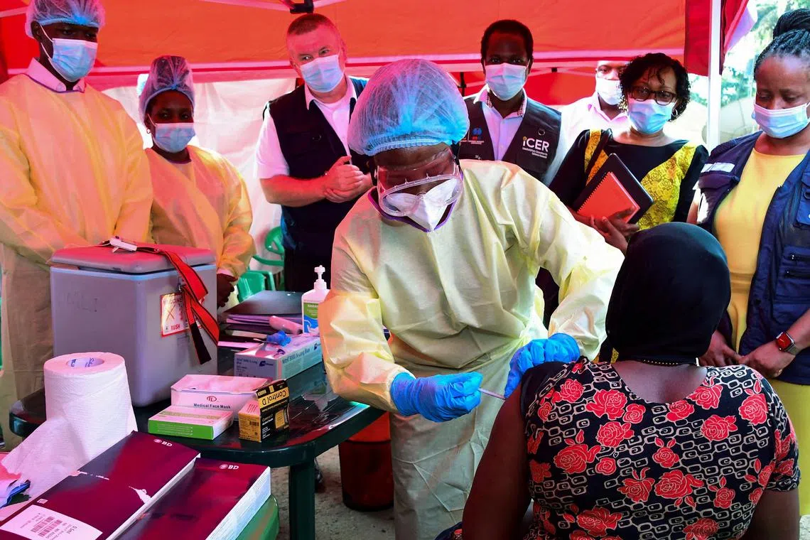 A Ugandan doctor vaccinates the contact of a patient who tested positive during the launch of the vaccination for the Sudan strain of the Ebola virus with a trial vaccine at the Mulago Guest House in Kampala, Uganda, on Feb 3. 