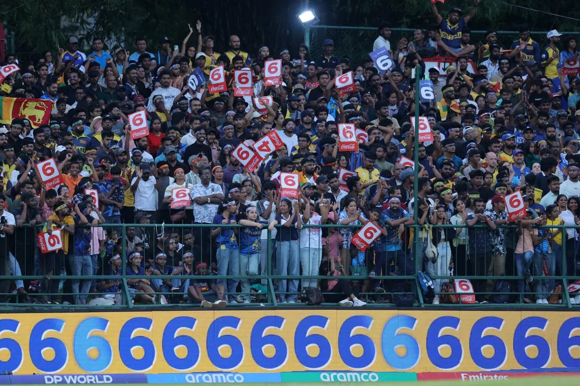 Cricket - ICC Men's T20 World Cup 2026 - Super 8 - Sri Lanka v England - Pallekele International Cricket Stadium, Kandy, Sri Lanka - February 22, 2026 Sri Lanka fans celebrate after Dasun Shanaka hits six runs off the bowling of England's Jamie Overton REUTERS/Lahiru Harshana