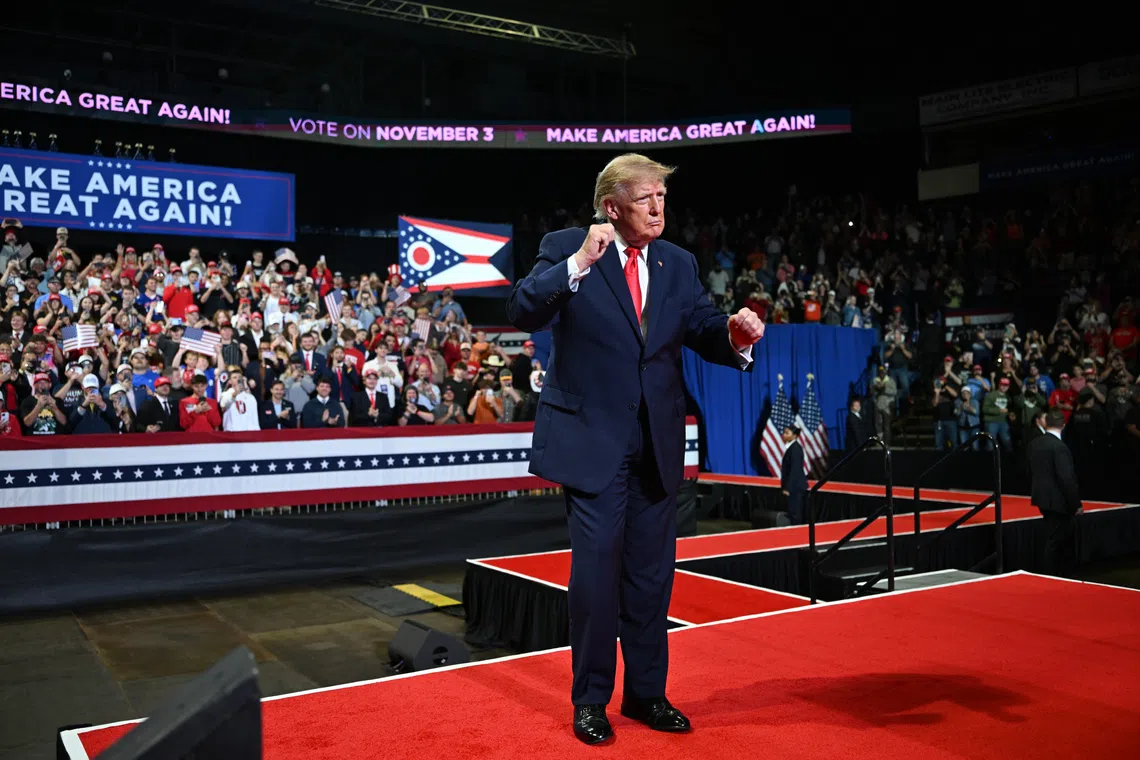 President Donald Trump on stage at a rally, where protester Blake Miley revealed a T-shirt with the message, “Release the Epstein Files,” on Oct 12 in Youngstown, Ohio.