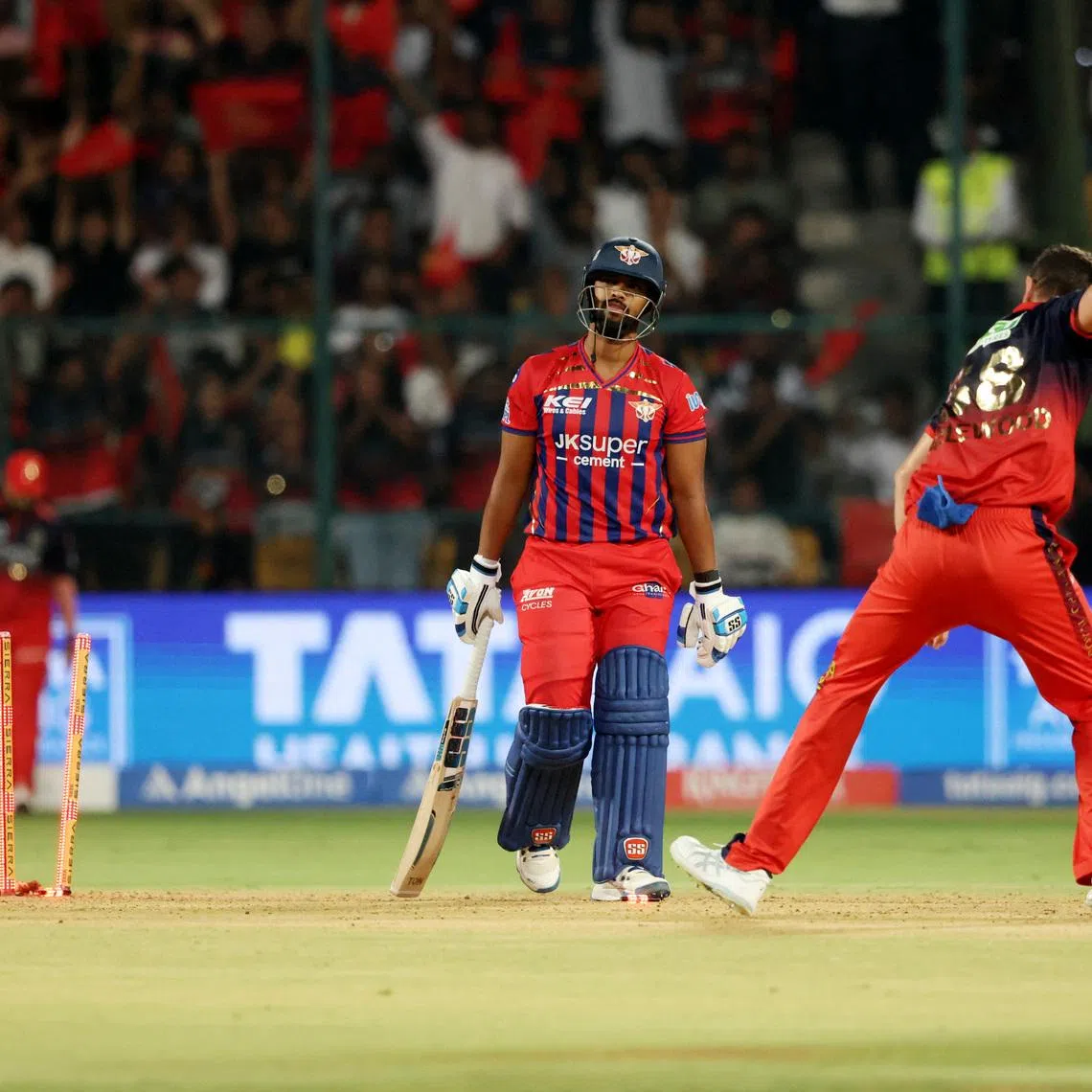 Cricket - Indian Premier League - IPL - Royal Challengers Bengaluru v Lucknow Super Giants - M. Chinnaswamy Stadium, Bengaluru, India - April 15, 2026 Lucknow Super Giants' Nicholas Pooran looks dejected after getting bowled out by Royal Challengers Bengaluru's Josh Hazlewood REUTERS/Priyanshu Singh