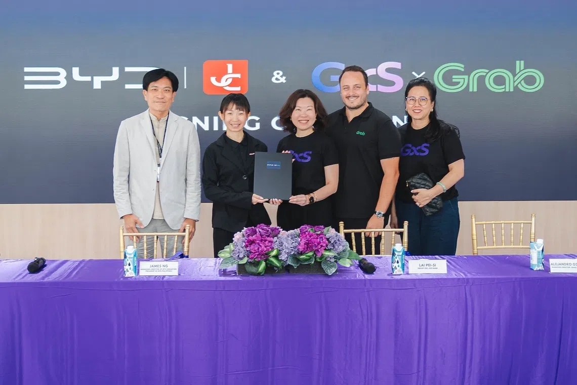 Managing director of BYD Singapore and president of BYD Philippines James Ng; CEO of BYD by JC Jessica Ang; group CEO of GXS Bank Lai Pei-Si; managing director of Grab Singapore Alejandro Osorio; and group head of retail of GXS Bank Jenn Ong at the green vehicle financing programme signing ceremony.