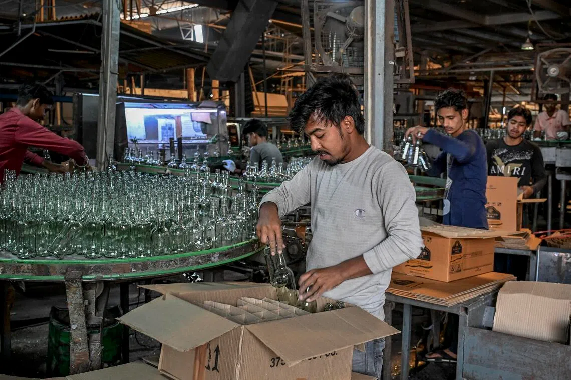 Workers at a glass factory in Firozabad, India, on April 21.