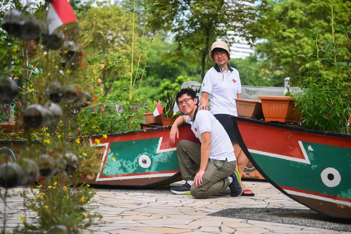 ST20250823_202528800769 Azmi Athni vlbloom//(from left) Mr Ang Jet Hong, 18, a student, and his mother Ms Eunice Teng, 59, a housewife, at the Garden of Love by Kelantan Residents' Network, which has a sampan theme, at 25 Jalan Berseh, on Aug 28, 2025.

ST PHOTO: AZMI ATHNI
