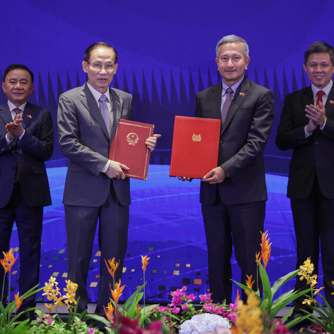 Foreign Minister Vivian Balakrishnan (second from right) and Vietnam Minister for Foreign Affairs Le Hoai Trung (second from left) exchange the agreements on Aug 25. With them are Coordinating Minister for Public Services Chan Chun Sing (far right) and his Vietnamese counterpart Tran Cam Tu.