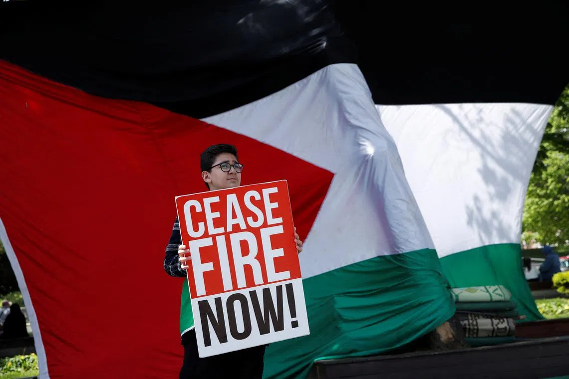 A demonstrator holds a placard during a protest in solidarity with Palestinians, amid the ongoing conflict between Israel and the Palestinian Islamist group Hamas, in Istanbul, Turkey, April 27, 2024. REUTERS/Dilara Senkaya