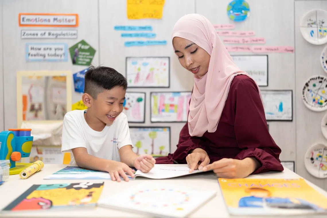 Ms Siti Ummu Aidilah Binte Badar, 29, reading a book with her son, Muhammad Al-Zai, Bin Muhammad Shafiq, 6.