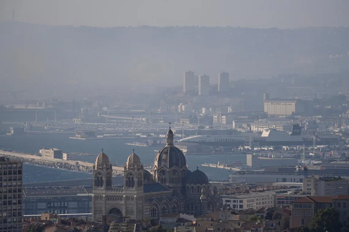 Smoke rises over Marseille as a fast-moving wildfire spreads on the outskirts the city, southern France, July 8, 2025. REUTERS/Alexandre Dimou