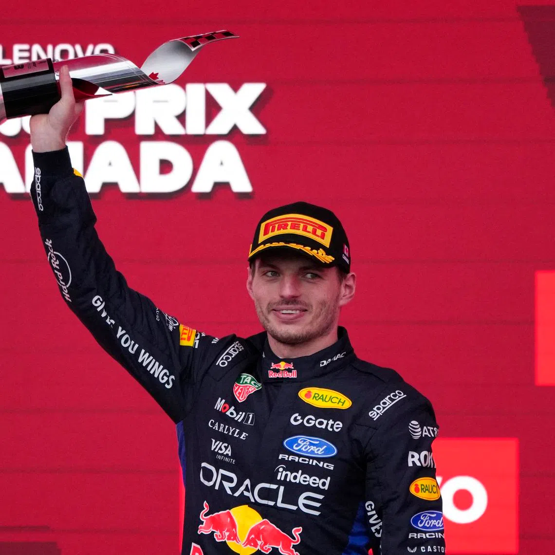 Formula One F1 - Canadian Grand Prix -  Circuit Gilles Villeneuve, Montreal, Quebec, Canada - May 24, 2026 Red Bull's Max Verstappen celebrates on the podium with a trophy after finishing third place in the Canadian Grand Prix REUTERS/Mathieu Belanger