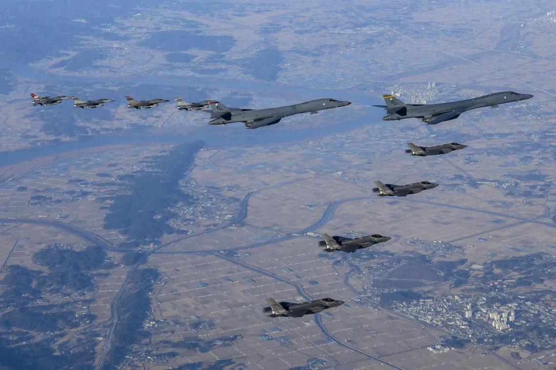 An undated handout photo made available by the South Korean Defence Ministry shows two US Air Force B-1B bombers, escorted by a squadron F-16 and F-35 fighter jets,  during joint war drills dubbed "Vigilant Storm".