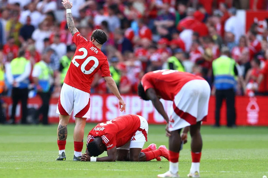 Soccer Football - Premier League - Nottingham Forest v Leicester City - The City Ground, Nottingham, Britain - May 11, 2025 Nottingham Forest's Taiwo Awoniyi reacts after sustaining an injury as Jota Silva looks on Action Images via Reuters/Andrew Boyers