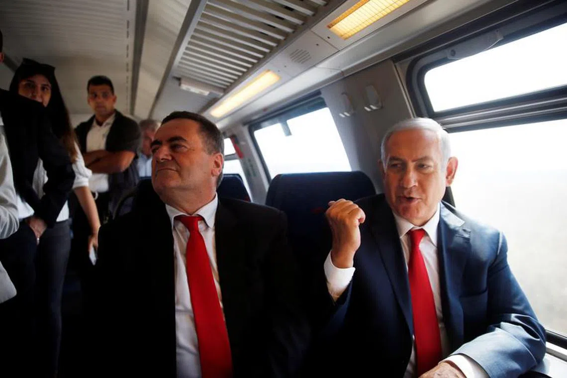 Israeli Prime Minister Benjamin Netanyahu (R) sits next to Israel's Transportation and Intelligence Minister Yisrael Katz during a test-run of the new high-speed train between Jerusalem and Tel Aviv, near Lod, Israel September 20, 2018. REUTERS/Ronen Zvulun/File Photo