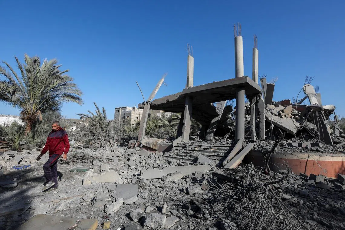 A Palestinian man walks at the site of an Israeli strike on a house, amid the Israel-Hamas conflict, in Deir Al-Balah in the central Gaza Strip December 4, 2024. REUTERS/Ramadan Abed