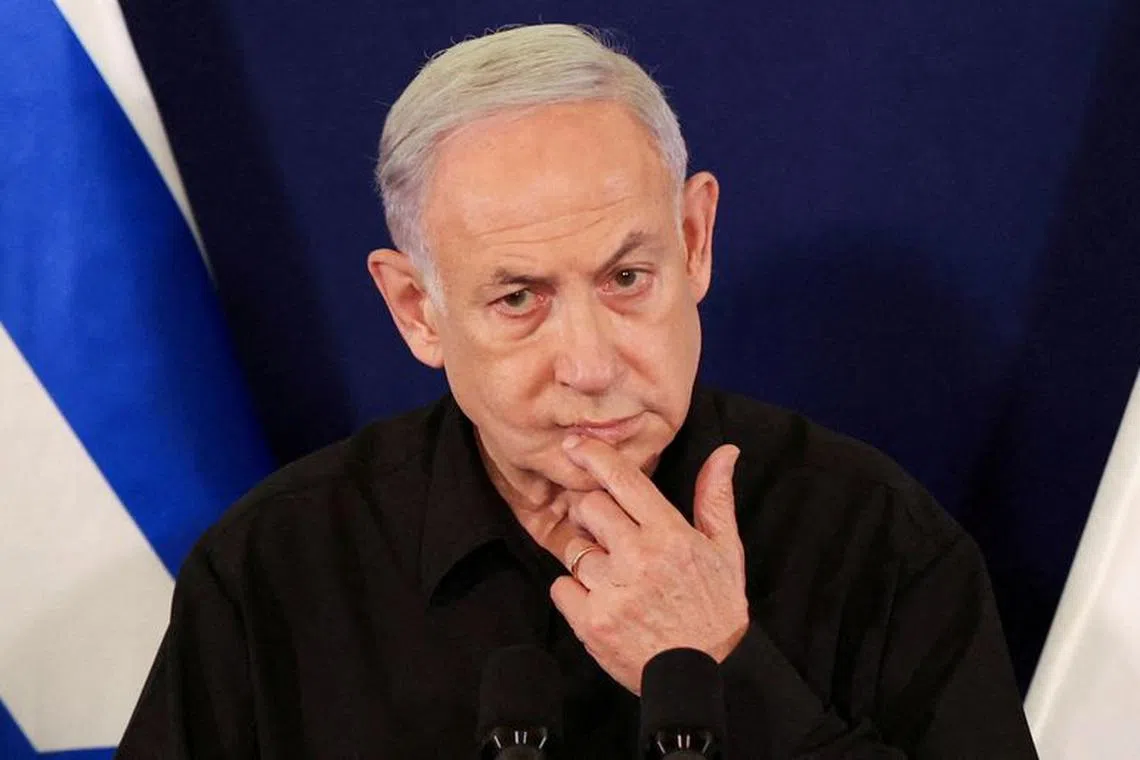 FILE PHOTO: Israeli Prime Minister Benjamin Netanyahu speaks during a press conference with Defense Minister Yoav Gallant and Cabinet Minister Benny Gantz in the Kirya military base in Tel Aviv , Israel , 28 October  2023. ABIR SULTAN POOL/Pool via REUTERS