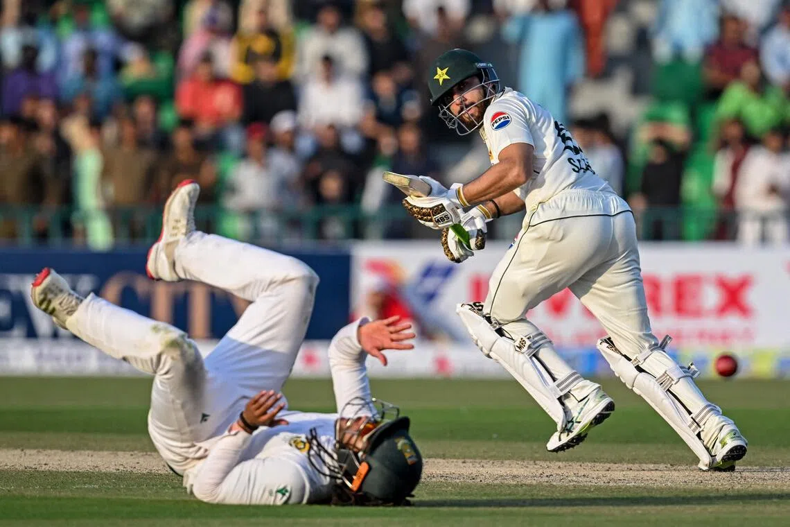 Pakistan's Salman Agha watches the ball after playing a shot on the first day of the first cricket Test against South Africa at the Gaddafi Stadium in Lahore on Oct 12, 2025.