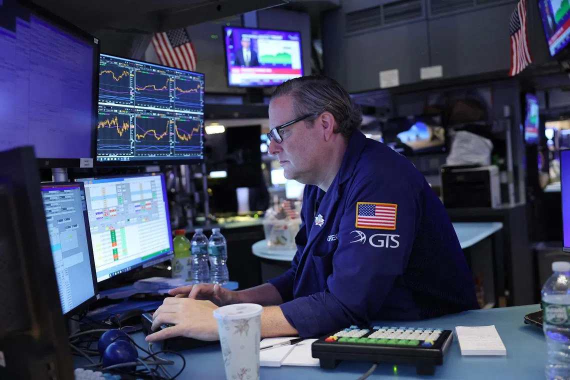 Traders work on the floor of the New York Stock Exchange, in New York City.