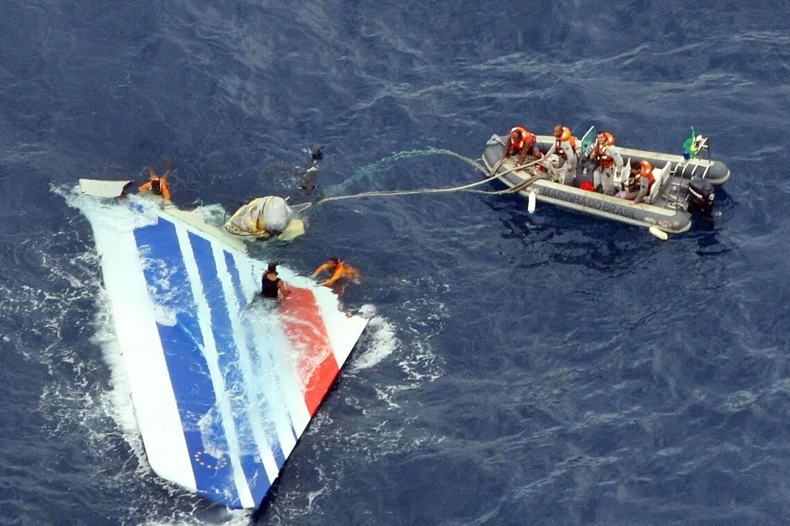 A file handout photo by the Brazilian Navy shows divers recovering part of the tail section from the Air France A330 aircraft that crashed in midflight over the Atlantic ocean on June 1, 2009.
