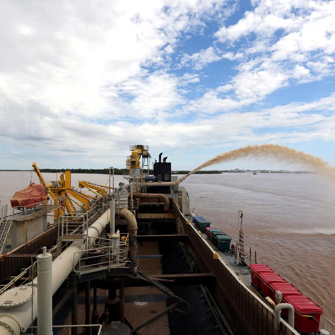 FILE PHOTO: A dredging boat of the Luxembourg-based company Jan De Nul sprays sand at the shore on the Parana river near Rosario, Argentina, January 31, 2017.  Picture taken January 31, 2017. REUTERS/Marcos Brindicci/File Photo