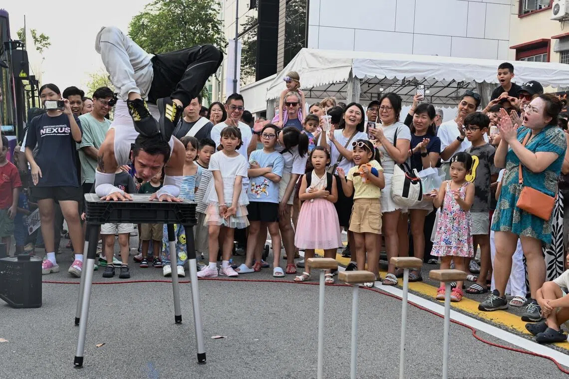 A contortionist perform on the streets at the Joo Chiat Car-Free Day. The 530m stretch was split into multiple zones, as auxiliary police officers guarded the barricaded areas to ensure safety.