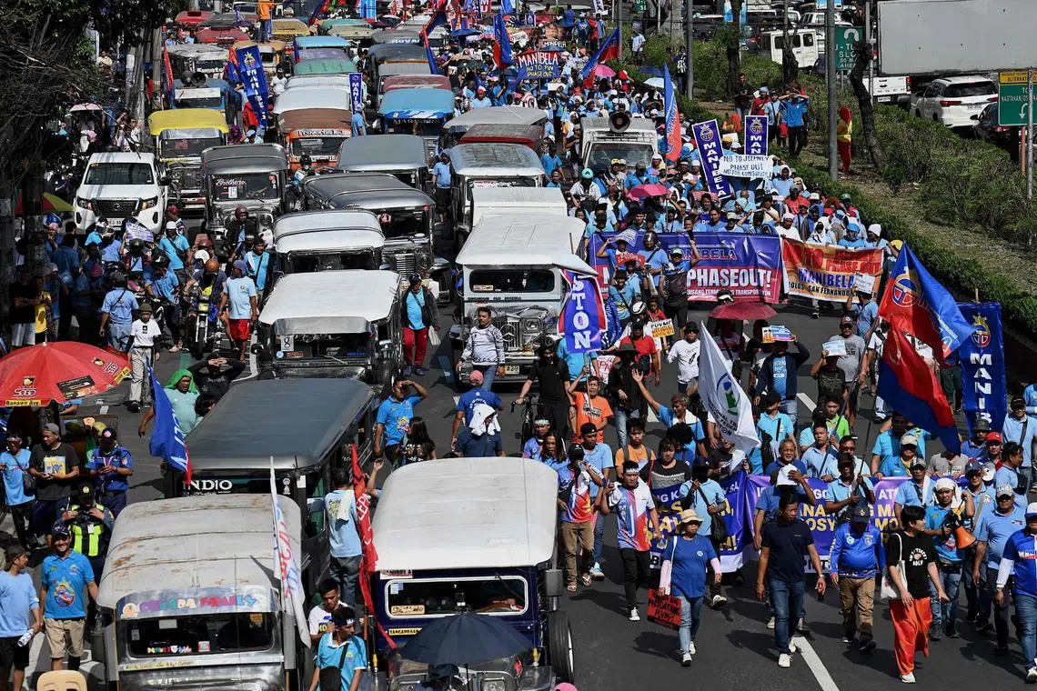 Jeepney drivers and operators march during a protest against the jeepney modernisation programme in Manila.