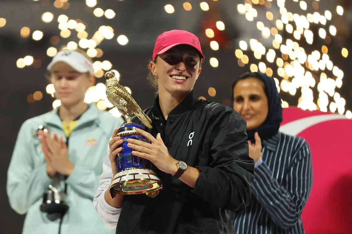 Poland's Iga Swiatek celebrates with the trophy after winning the final against Kazakhstan's Elena Rybakina.