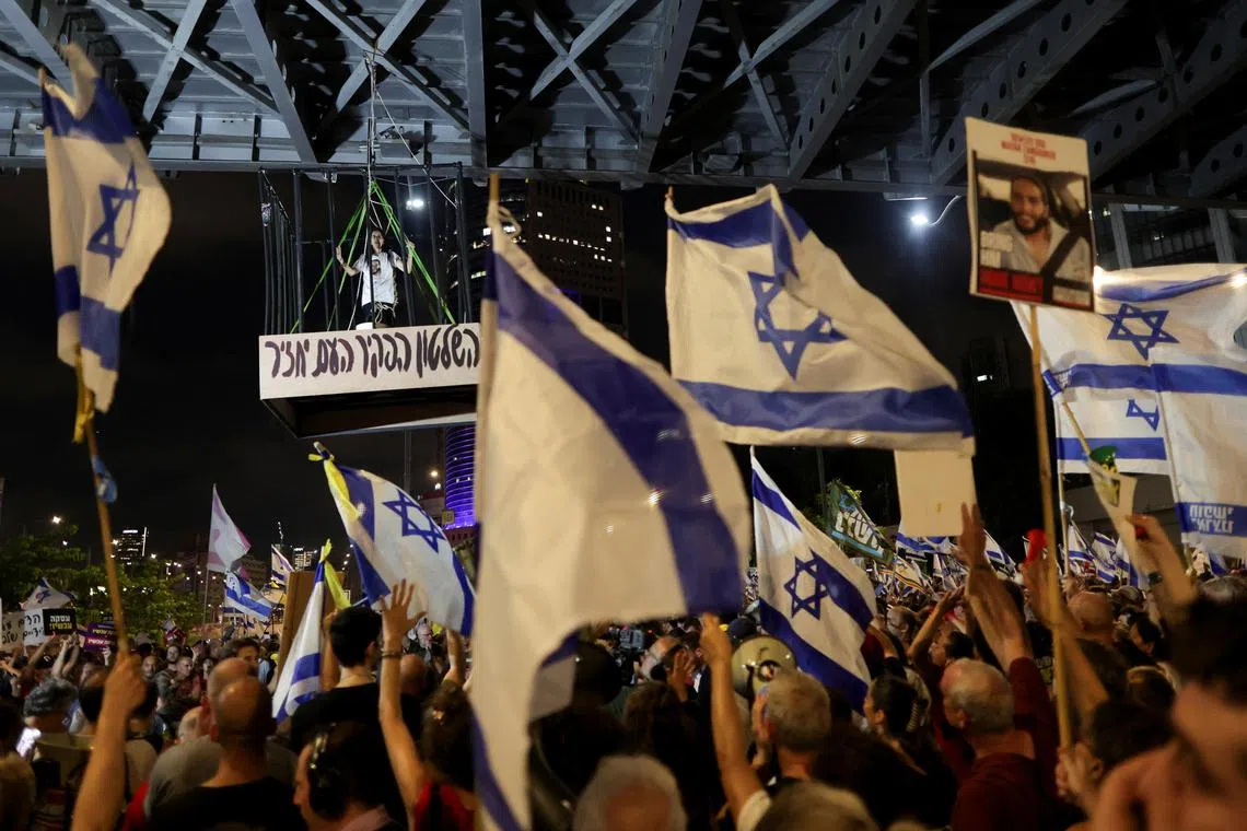 Ms Einav Zangauker, mother of one of the hostages, portrays herself as a hostage in a cage during an anti-government demonstration to mark nine months since the deadly Oct 7 attack.