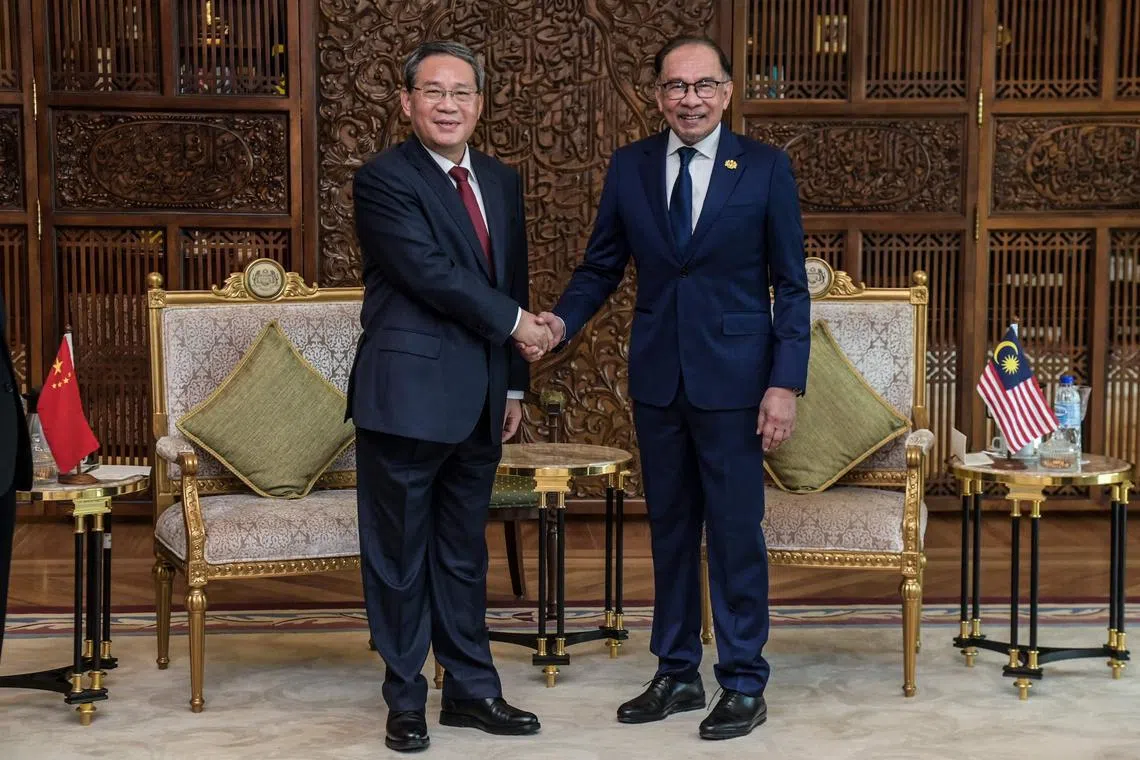 Visiting Chinese premier Li Qiang (left) met Malaysia premier Anwar Ibrahim at the Prime Minister's office in Putrajaya, on June 19. 