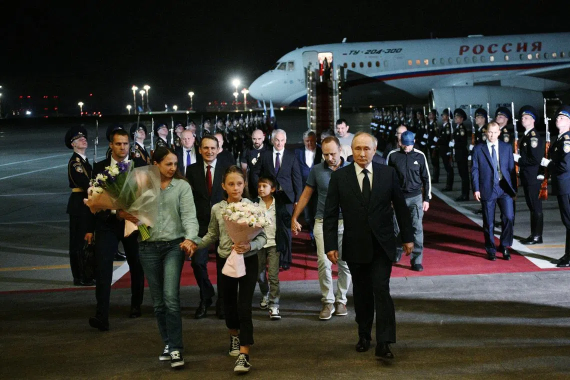 Russian President Vladimir Putin welcomes Russian nationals, including Artyom Dultsev, Anna Dultseva and their children, following a prisoner exchange between Russia with Western countries, during a ceremony at Vnukovo International Airport in Moscow, Russia August 1, 2024. Sputnik/Kirill Zykov/Pool via REUTERS ATTENTION EDITORS - THIS IMAGE WAS PROVIDED BY A THIRD PARTY.