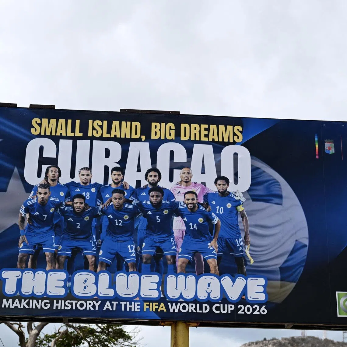 View of a banner depicting the Curacao national football team in Willemstad, in the Dutch Caribbean, on April 11, 2026. Curacao are the smallest country ever, by population, to qualify for football’s World Cup.