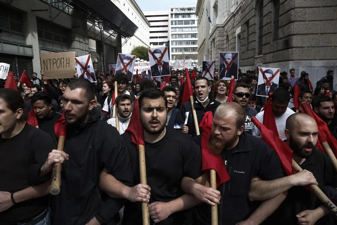 Protesters threw red paint of the pillars of Bank of Greece's building during a nationwide 24-hour strike in Thessaloniki, northern Greece on March 8, 2023. 