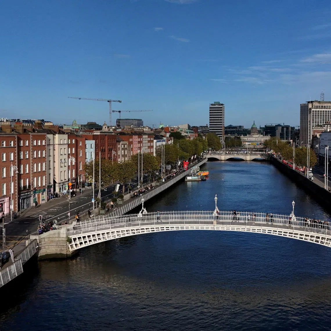 FILE PHOTO: A drone view shows people walking over the Ha'penny Bridge on the river Liffey with the Spire visible, in the city centre of Dublin, Ireland October 7, 2024. REUTERS/Clodagh Kilcoyne/File Photo