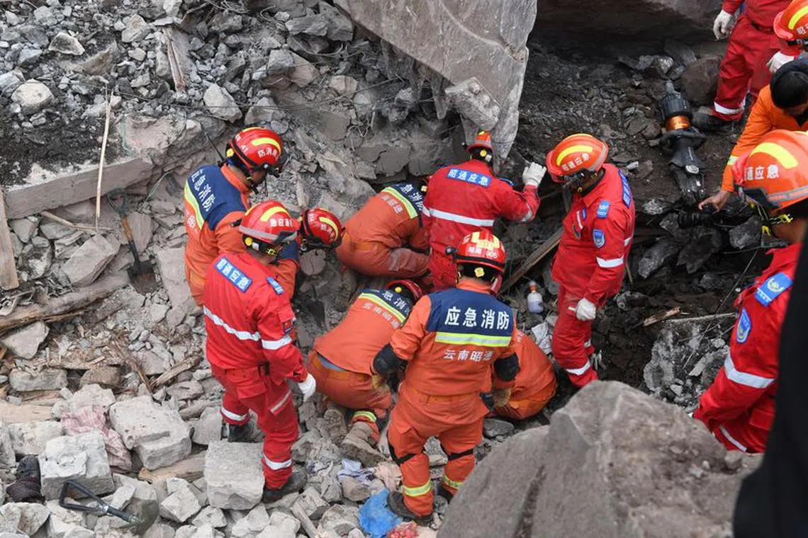Rescue workers search for survivors in the debris after a landslide hit Zhenxiong County, in Zhaotong, Yunnan province, China January 22, 2024. China Daily via REUTERS
