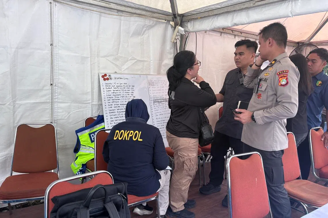 A police post outside the Bekasi Regional Public Hospital in West Java on April 28, with a whiteboard containing the names of the victims of the train accident.