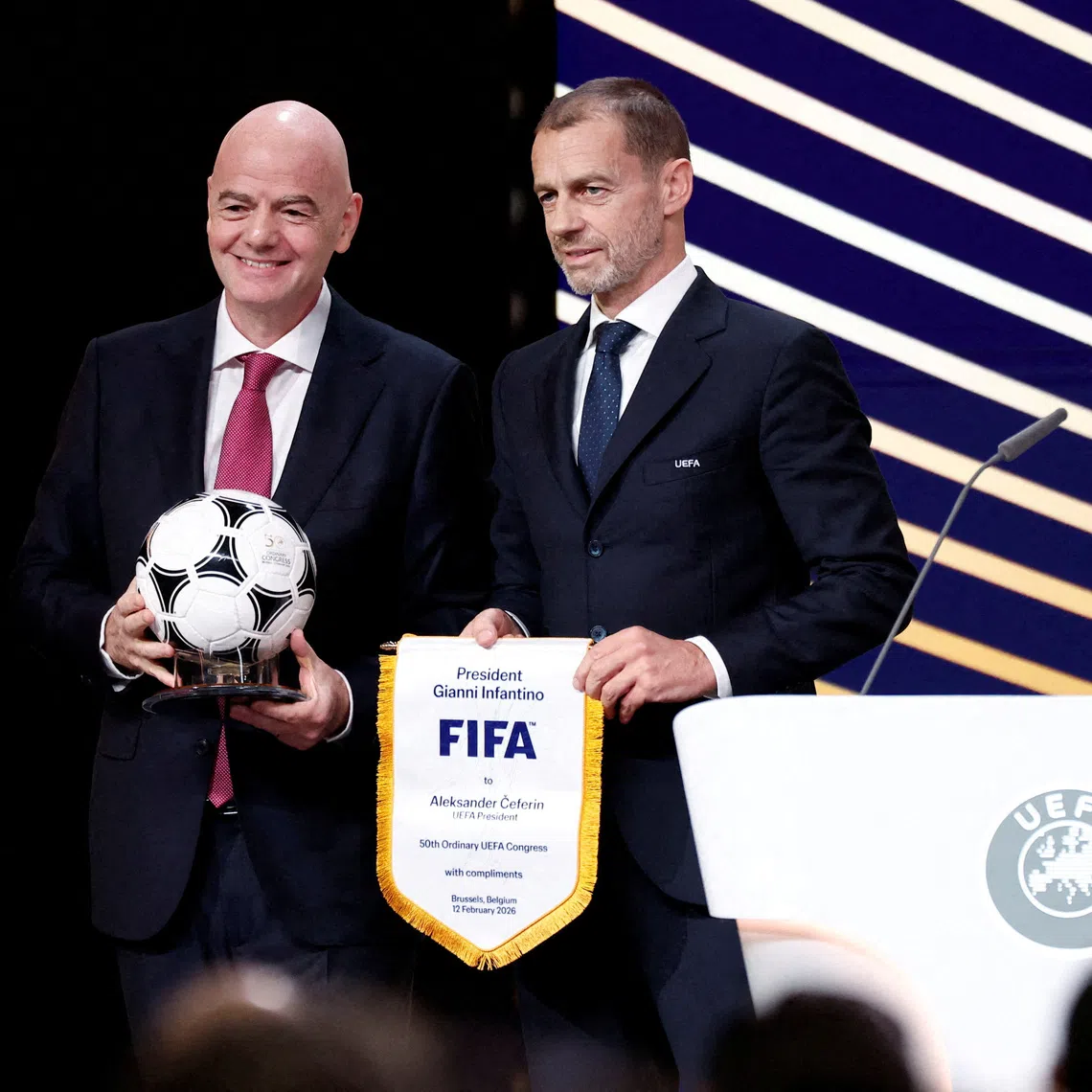 FILE PHOTO: Soccer Football - 50th Ordinary UEFA Congress - Brussels Expo, Brussels, Belgium - February 12, 2026 UEFA president Aleksander Ceferin and FIFA president Gianni Infantino pose for a photograph during the event REUTERS/Benoit Tessier/File Photo