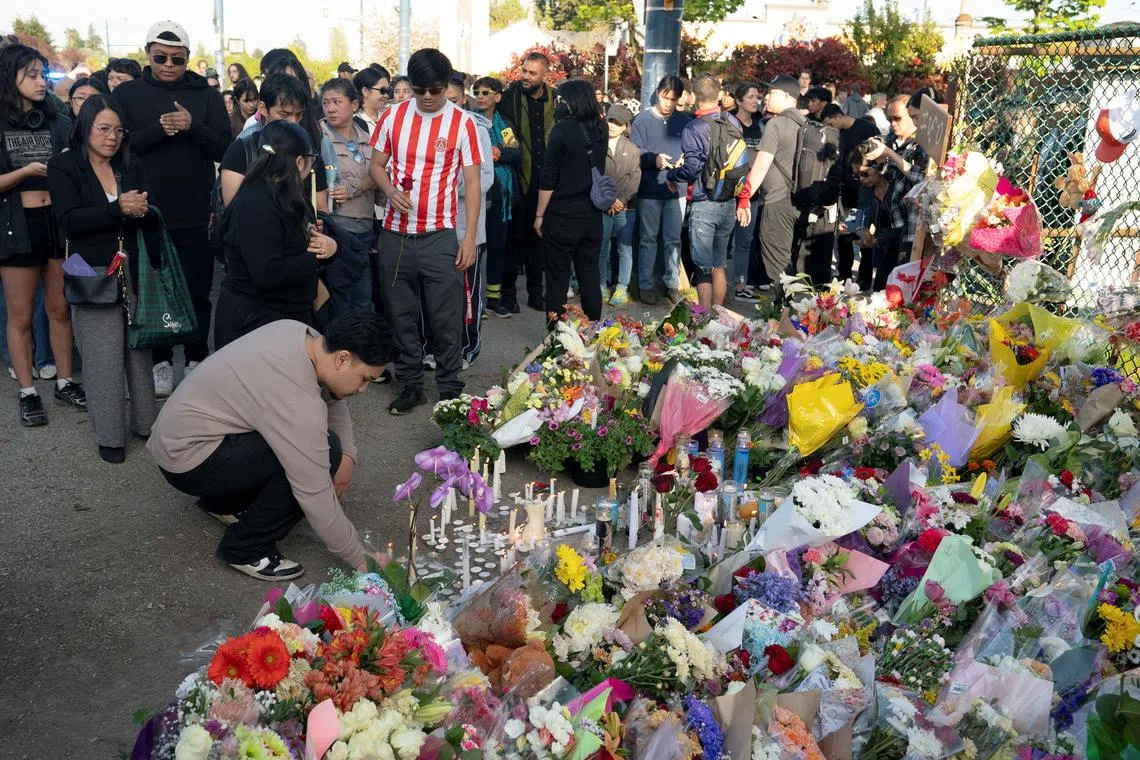 People gather to mourn together the day after a vehicle was driven into a crowd at a Filipino community Lapu Lapu day block party, in Vancouver.