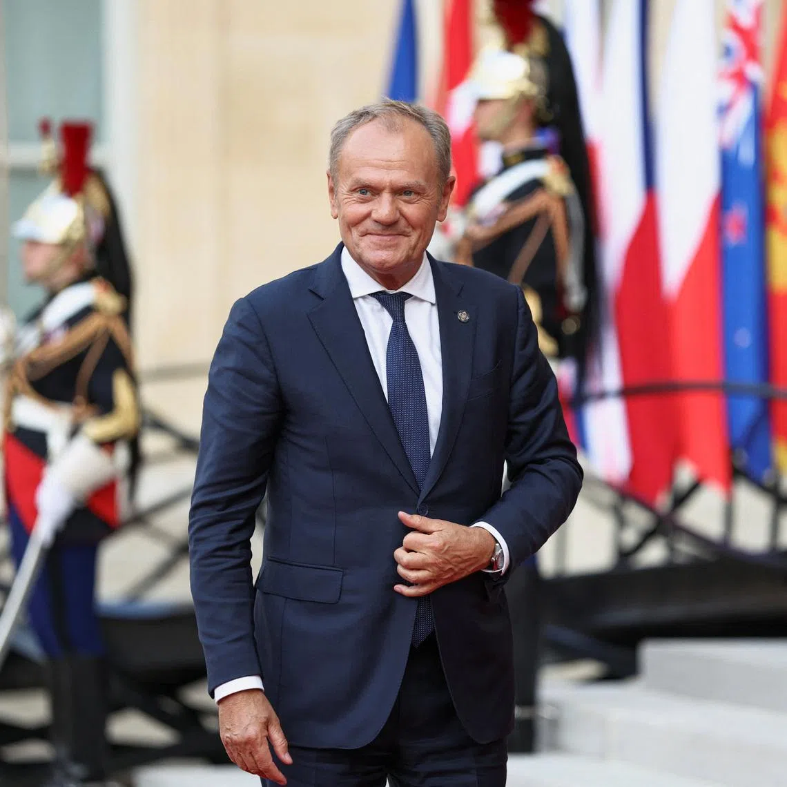 Polish Prime Minister Donald Tusk arrives for a dinner of the 'Coalition of the Willing', a coalition of countries that have extended their support to Ukraine, on the eve of Bastille Day celebrations, at the Elysee Palace in Paris, France, July 13, 2026. REUTERS/Tom Nicholson