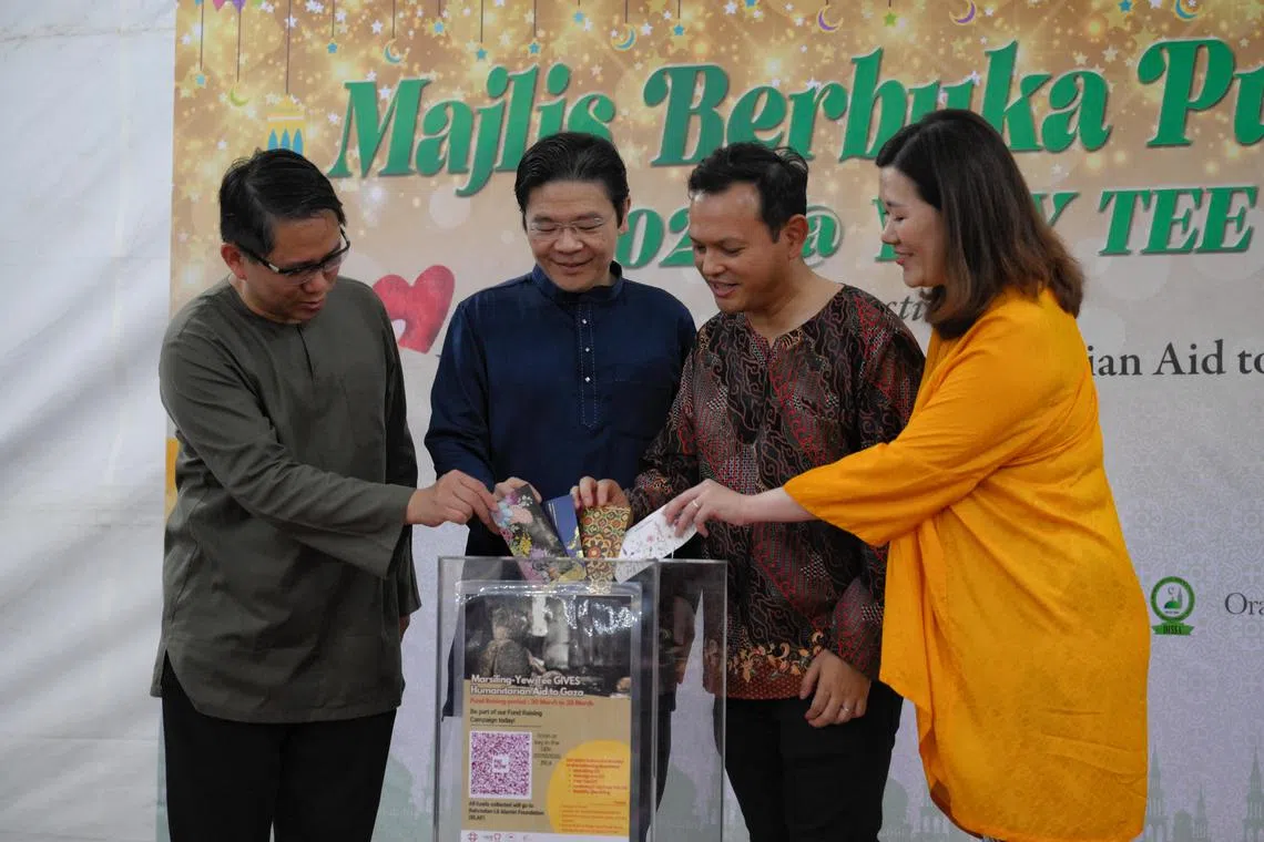 From left, Alex Yam, Mayor of North West District, and Adviser to Marsiling-Yew Tee GRC GROs (Yew Tee), Deputy Prime Minister Larence Wong , Zaqy Mohamad, Senior Minister of State for Defence and Manpower, and Adviser to Marsiling-Yew Tee GRC GROs (Marsiling)and Hany Soh, Adviser to Marsiling-Yew Tee GRC GROs (Woodgrove), insert notes into a donation box during the launch of the Initiative “Marsiling-Yew Tee Gives: Humanitarian Aid to Gaza” held on March 24, 2024.
