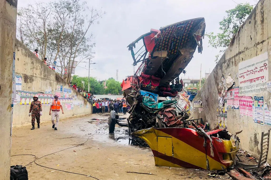 People gather after a bus met with an accident in Madaripur on Sunday morning, leaving at least 19 dead.  