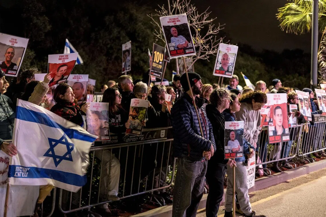 Protesters lifting national flags and portraits of Israelis held hostage by Hamas militants in Gaza since Oct 7, during a rally demanding their release outside Israeli Premier Benjamin Netanyahu's private residence on Jan 27.