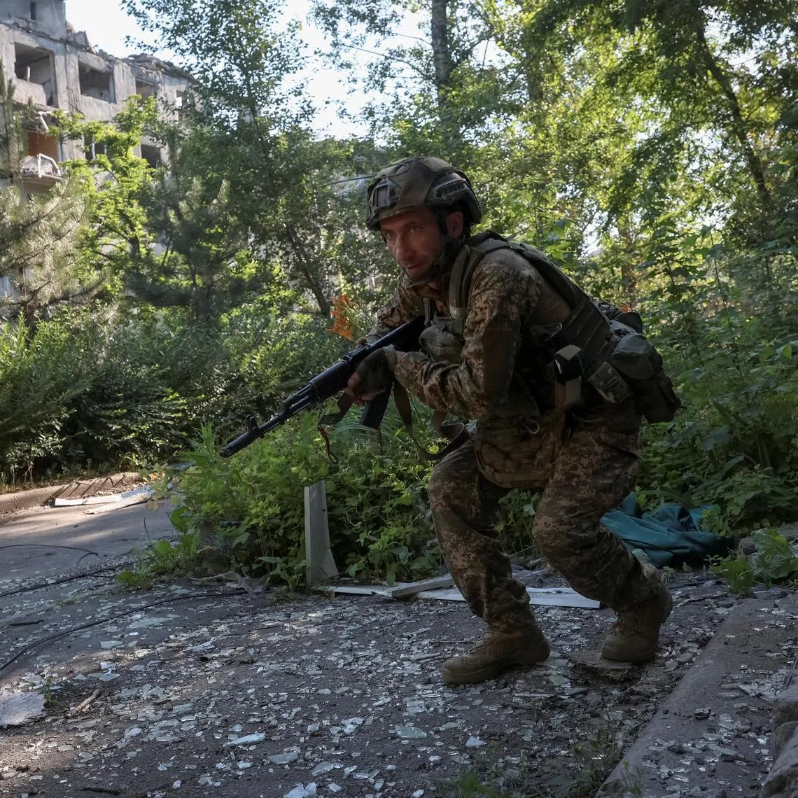A serviceman of the 15th 'Kara-Dag' Brigade of the Operational Assignment of the National Guard of Ukraine runs near a destroyed apartment building during his combat mission, amid Russia's attack on Ukraine, in the frontline town of Dobropillia, in the Donetsk region, Ukraine June 29, 2026. REUTERS/Anatolii Stepanov