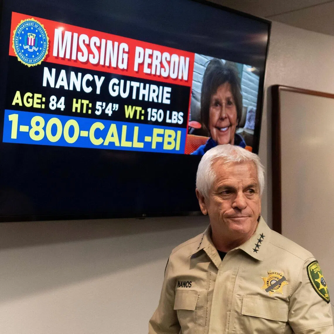 Pima County Sheriff Chris Nanos exits the press room past a missing persons poster after giving an update on the investigation after the disappearance of Ms Nancy Guthrie. 