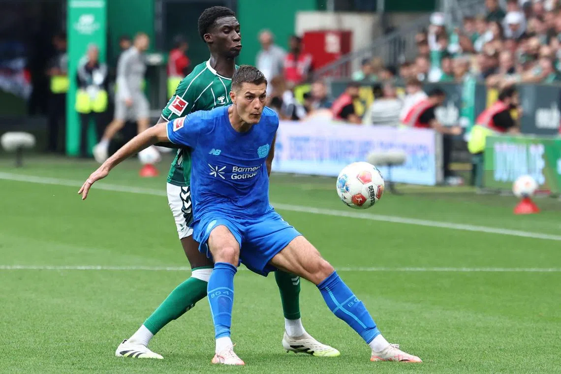 Werder Bremen's German defender Karim Coulibaly marking Bayer Leverkusen's Czech forward Patrik Schick in their German Bundesliga football match in Bremen on Aug 30, 2025.