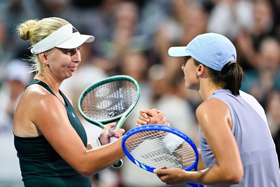 Iga Swiatek (right) congratulating Clara Tauson for her victory in the Canadian Open round of 16 on Aug 3.
