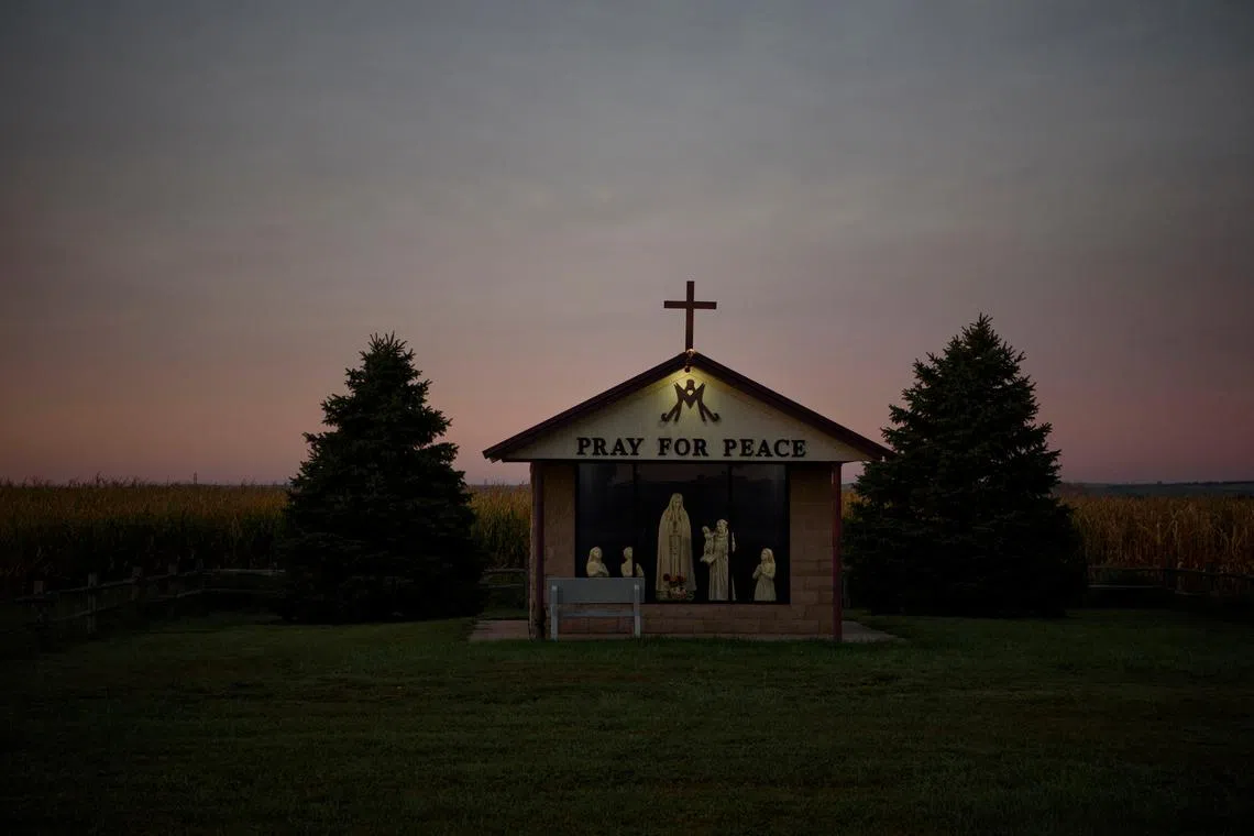 The sun rises over a Catholic monument near Wagner, South Dakota, U.S., September 9, 2021.     REUTERS/Callaghan O'Hare/File Photo