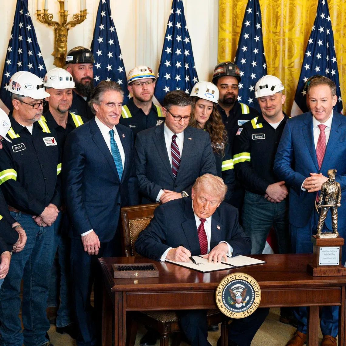 President Donald Trump signs an executive order during a coal-powered energy event at the White House on Feb 11.