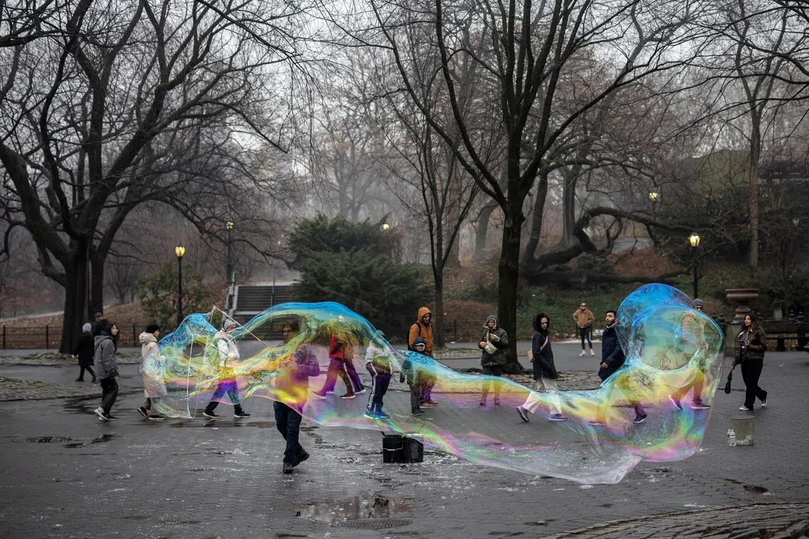 A man makes a giant bubble at Central Park in Manhattan in New York City, U.S., December 28, 2024. REUTERS/Marko Djurica     TPX IMAGES OF THE DAY     