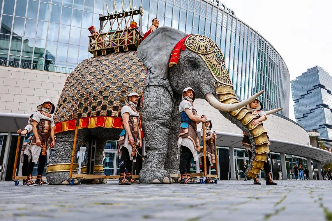 Artists in costumes presenting an artificial five-meter tall elephant to promote the upcoming opera show 'AIDA - The Arena Opera Spectacle' in Berlin, Germany, Oct 10. 