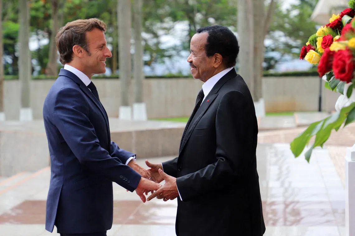 FILE PHOTO: Cameroon's President Paul Biya welcomes his French counterpart Emmanuel Macron at the presidential palace in Yaounde, Cameroon, July 26, 2022. REUTERS/Desire Danga Essigue/File photo